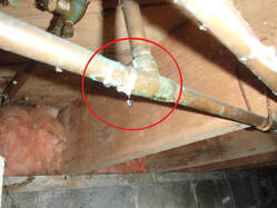 building inspector finds pipe leak in crawl space